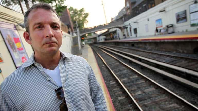 Neil Hicks poses at the Great Neck LIRR station on...