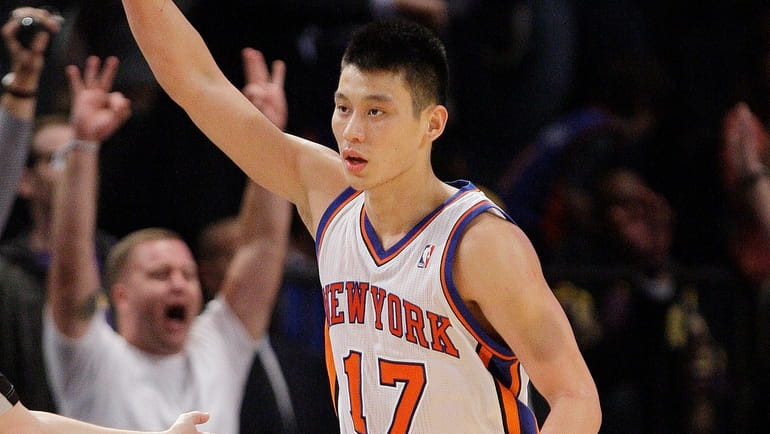 The Knicks' Jeremy Lin reacts after making a 3-point basket...