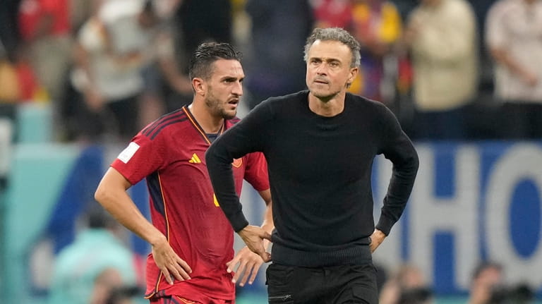 Spain's Koke and head coach Luis Enrique react at the...