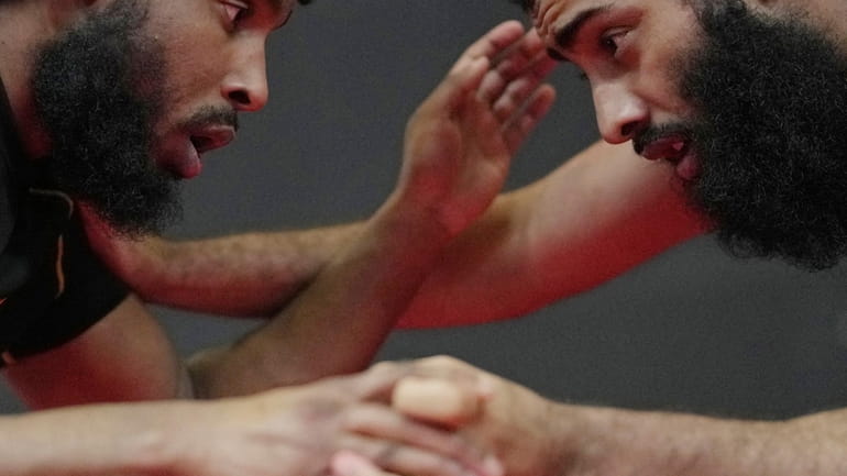 Flyweight MMA fighter Sabir Hussein, left, practices mixed martial arts...