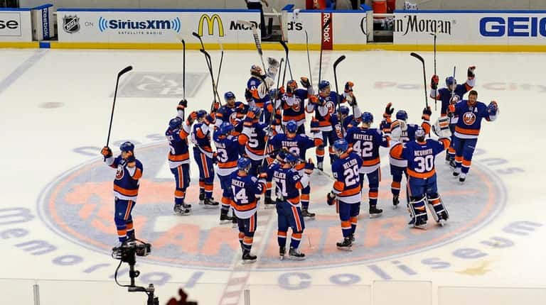 The Islanders salute the fans April 25, 2015, after winning...