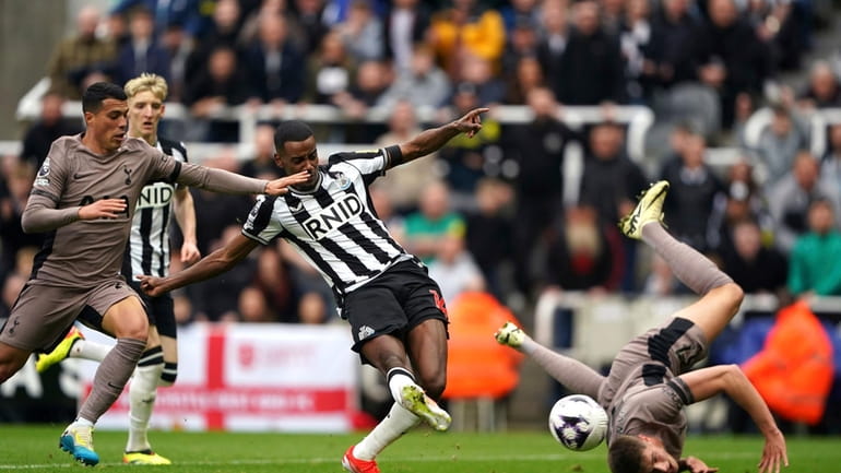 Newcastle United's Alexander Isak, centre, scores the opening goal during...
