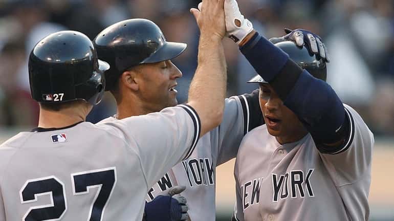 The Yankees' Alex Rodriguez, right, is congratulated by Derek Jeter,...