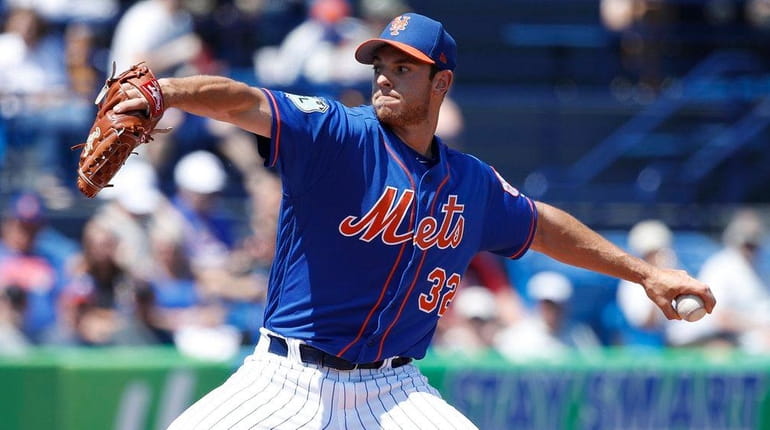 Steven Matz #32 of the New York Mets pitches in...