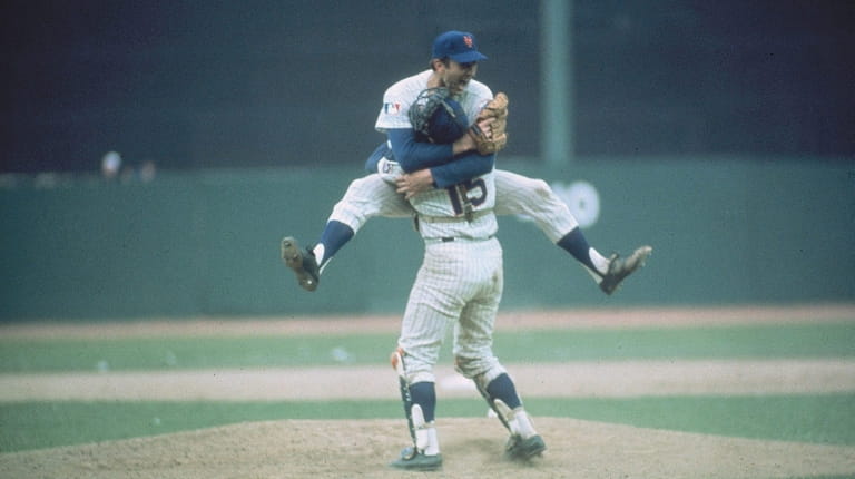 Mets pitcher Jerry Koosman hugs Jerry Grote after winning the...