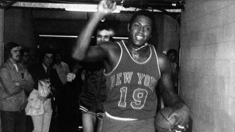 Willis Reed of the New York Knicks happily trots to...