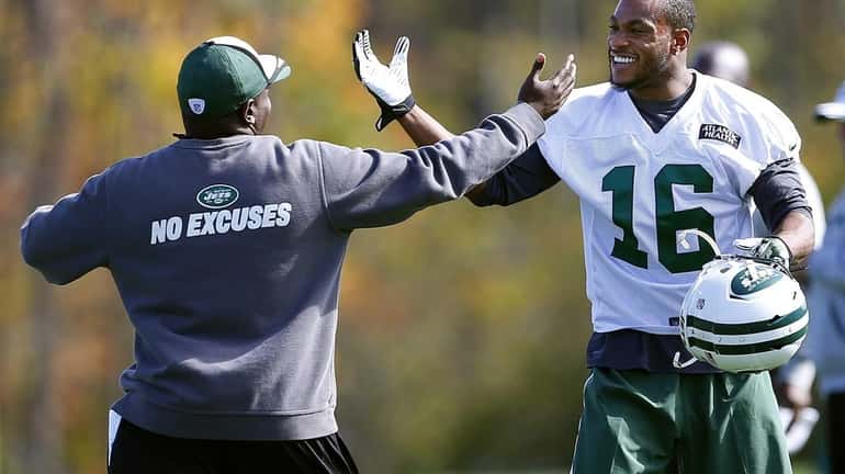Jets wide receiver Percy Harvin (16) is greeted by assistant...