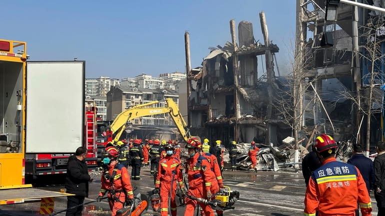 Firefighters work the scene of an explosion in Sanhe city...