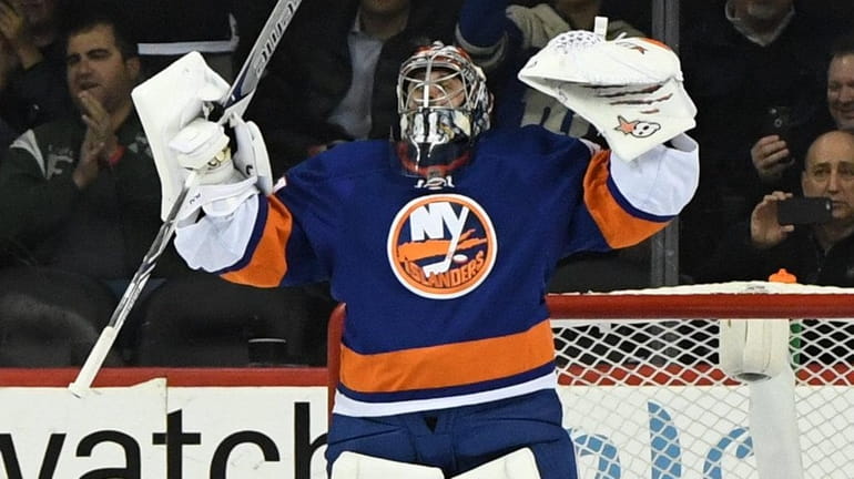 New York Islanders goalie Jaroslav Halak reacts as time runs...