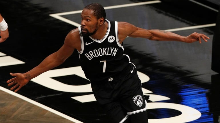 Kevin Durant of the Nets reacts after a basket during the...