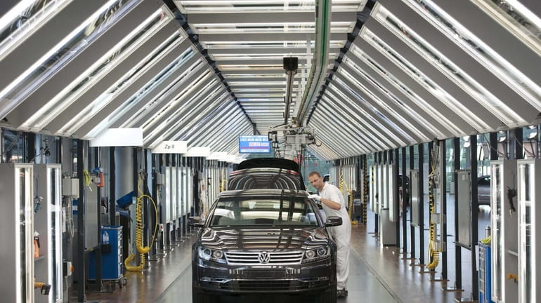 Thomas Mehlhose works at the assembly line for the Volkswagen...