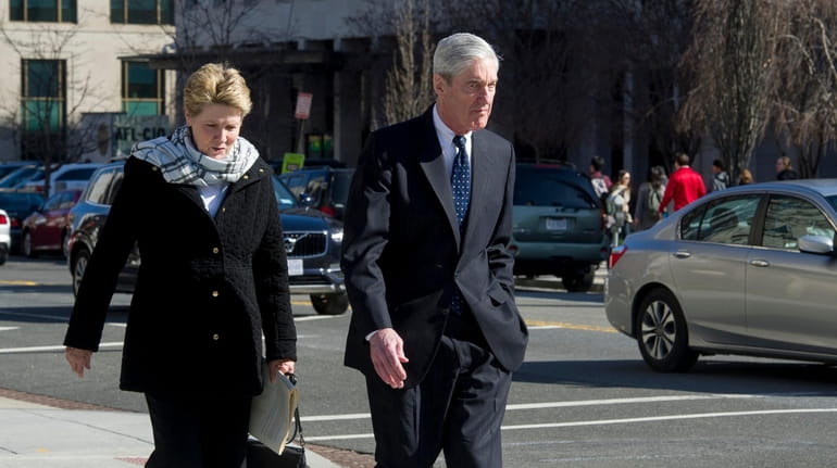 Special Counsel Robert Mueller, and his wife Ann, walk to...