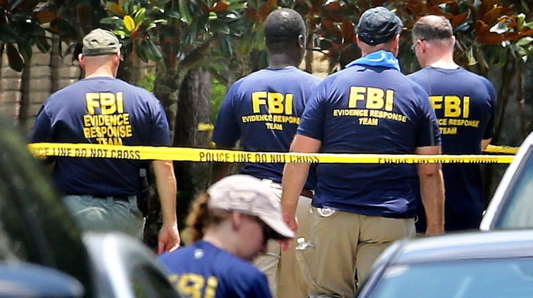 FBI agents return to the scene of the mass shooting...