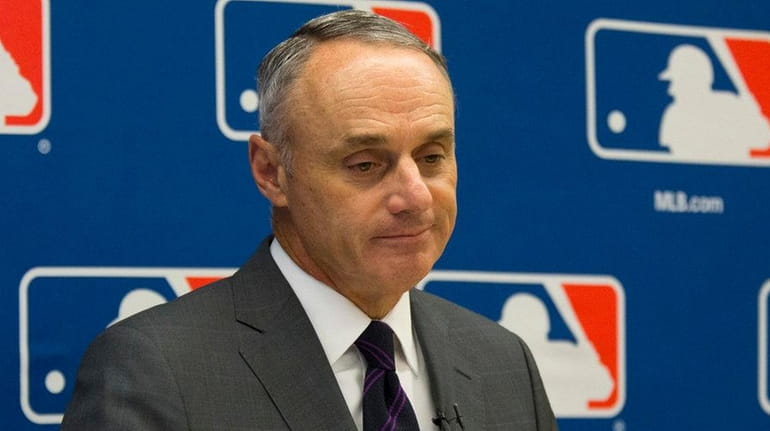 Major League Baseball commissioner Rob Manfred speaks to reporters during...