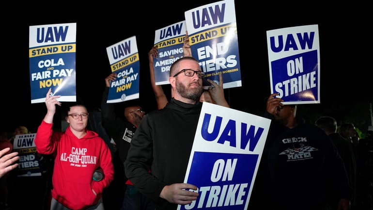 Striking United Auto Workers picket at Ford's Michigan Assembly Plant...
