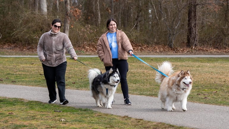 Erica Anker, left, and Rachel Anker, both of Mount Sinai, walk...