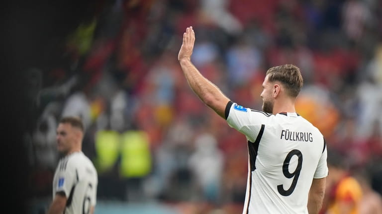 Germany's Niclas Fuellkrug waves at the end of the World...