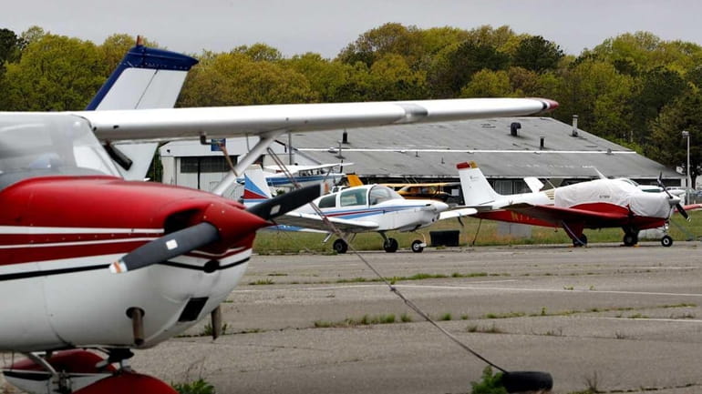 Planes at their tiedown pads and hangers at Brookhaven Calabro...