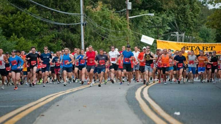 Participants begin the 34th Great Cow Harbor 10K run. (Sept....