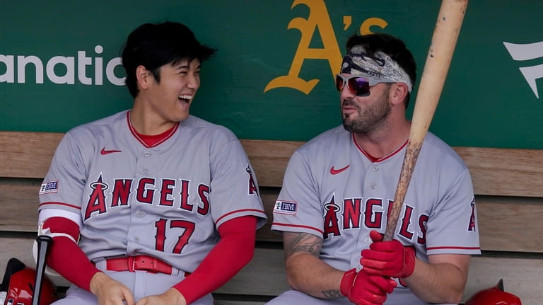 Los Angeles Angels' Shohei Ohtani (17) laughs in the dugout...