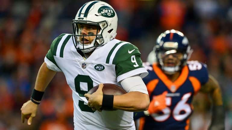 Bryce Petty of the Jets carries the ball while chased...