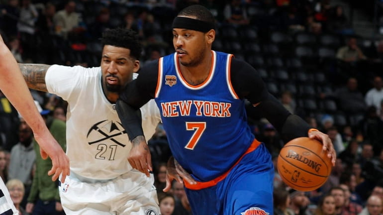 New York Knicks forward Carmelo Anthony, right, drives to the...
