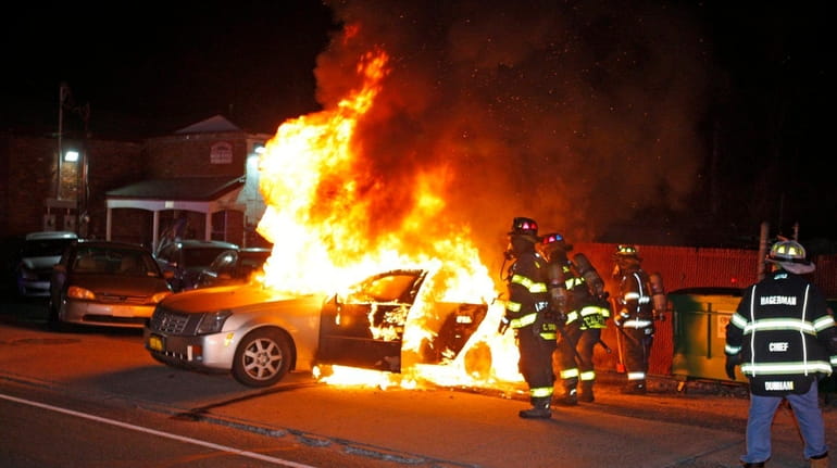 Firefighters at an East Patchogue auto repair center, where a...
