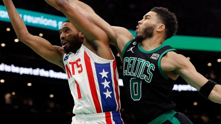 The Celtics' Jayson Tatum fouls the Nets' Mikal Bridges during the first...