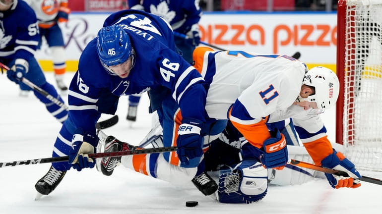 Maple Leafs defenseman Ilya Lyubushkin and Islanders left wing Zach Parise tussle...