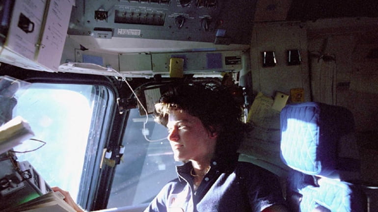 Astronaut Sally Ride, a specialist on shuttle mission STS-7, monitors...