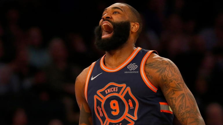 Kyle O'Quinn of the Knicks reacts after a basket in...