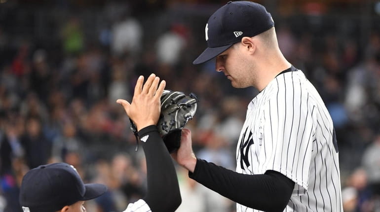 Ronald Torreyes greets Yankees pitcher Jordan Montgomery against the Reds...