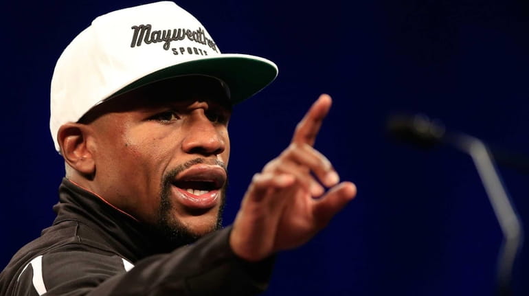Floyd Mayweather Jr. addresses the media during the post-fight news...