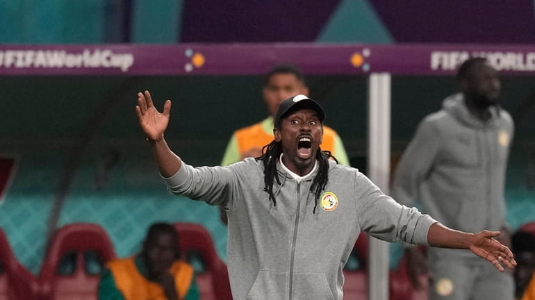 Senegal's head coach Aliou Cisse gives directions to his players...
