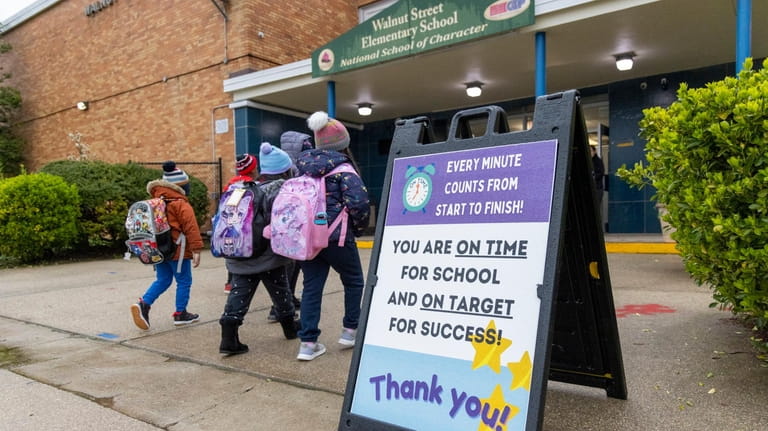 A sign encourages students outside Walnut Street Elementary School in...