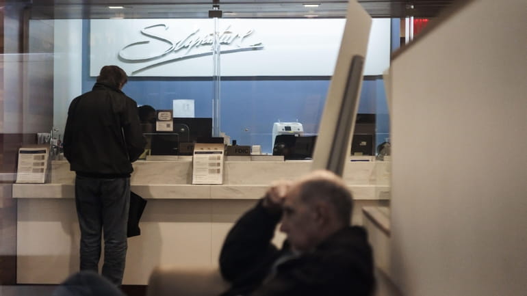 Customers in the lobby of a Signature Bank branch in...
