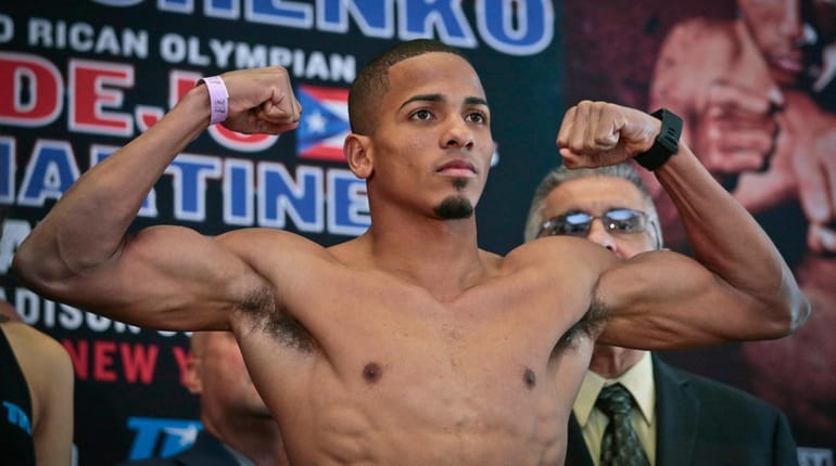 Puerto Rican boxer Felix Verdejo poses after his weigh-in, Friday...