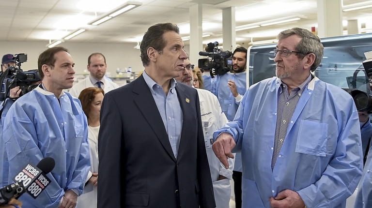 Gov. Andrew M. Cuomo, center, with state Health Commissioner Howard...