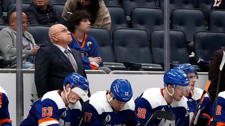 Islanders head coach Barry Trotz looks at the score board...
