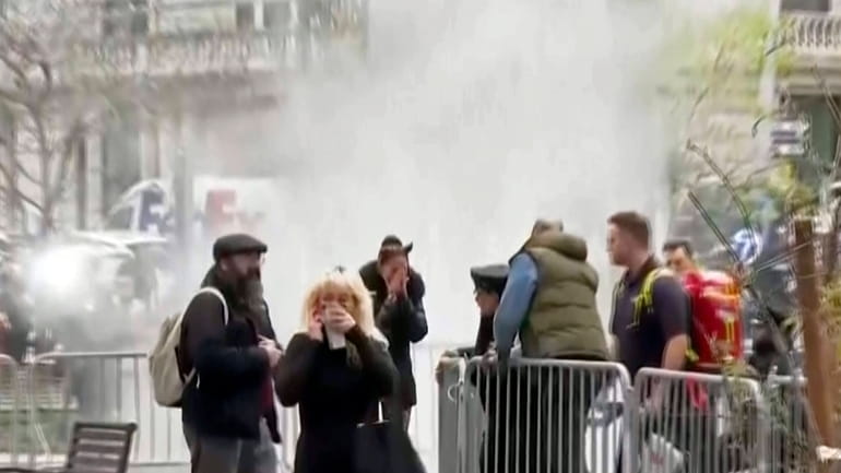 In this image taken from video, bystanders react after witnessing...