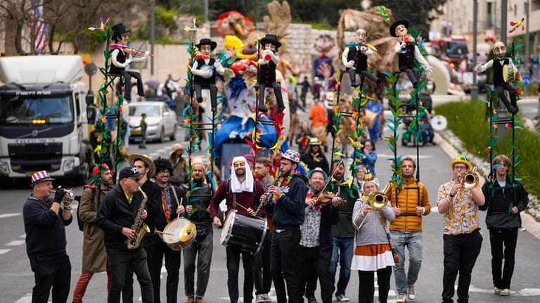 Performers play music during Purim parade in Jerusalem, Monday, March...
