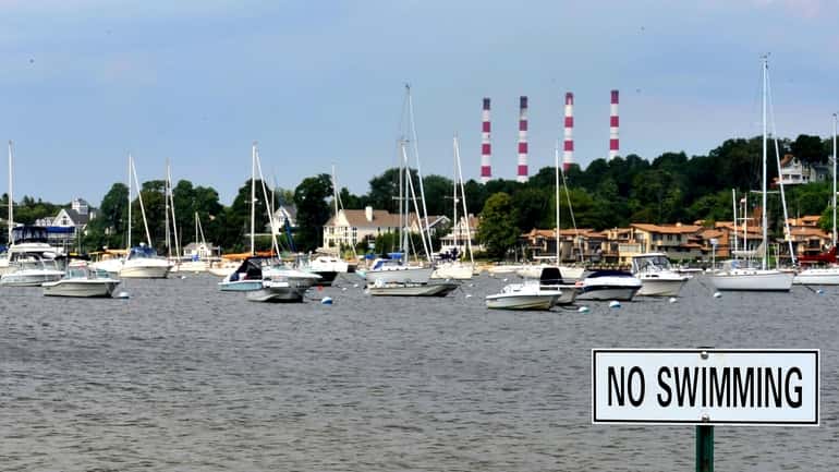 A 'no swimming' sign is posted on Centerport Yacht Club...