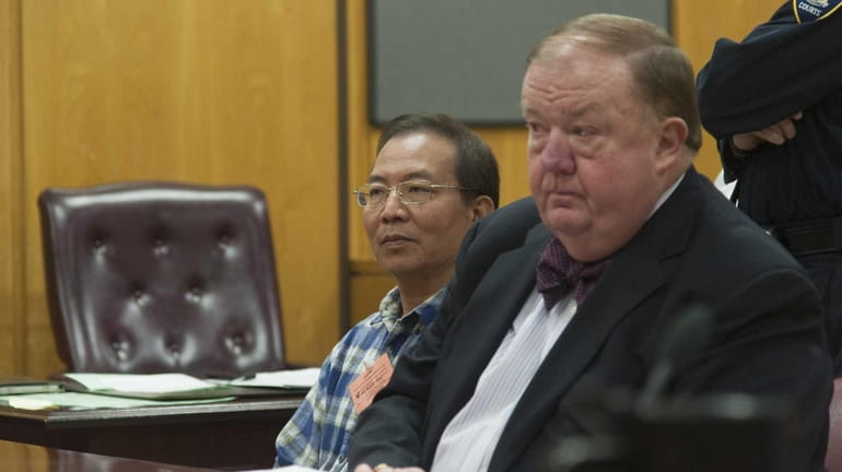 Dr. Stan Li, left, looks on as he is arraigned...