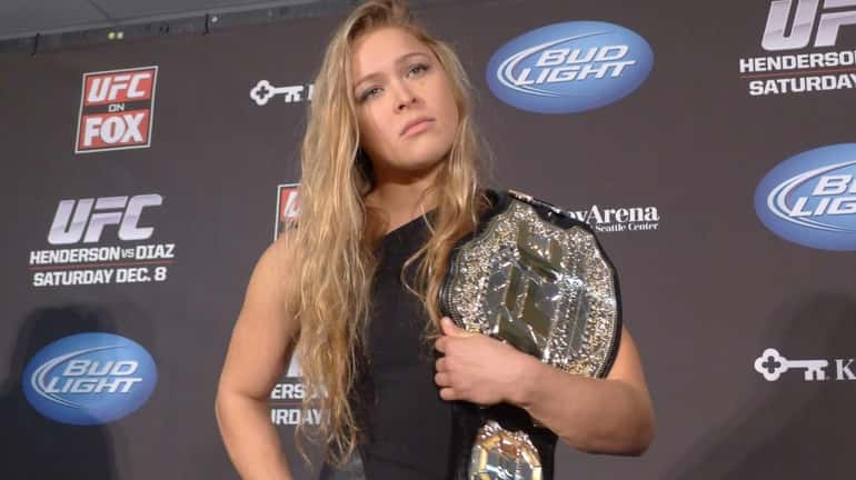 Ronda Rousey shows off her UFC bantamweight championship belt during...