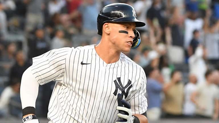New York Yankees' Aaron Judge rounds the bases on his...