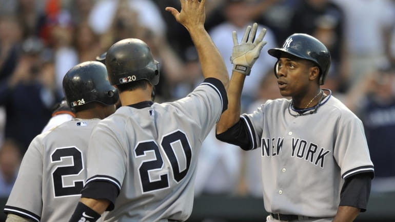 New York Yankees' Curtis Granderson, right, is congratulated by teammates...