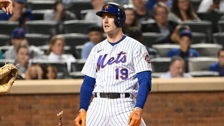 Mets leftfielder Mark Canha reacts after he struck out looking...