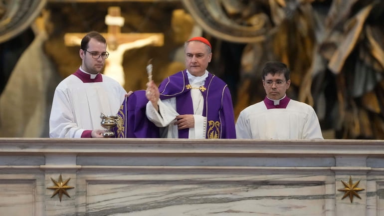 Cardinal Mauro Bassetti, center, blesses the altar of the confession...