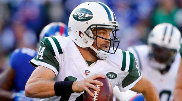 Ryan Fitzpatrick #14 of the New York Jets scrambles in...