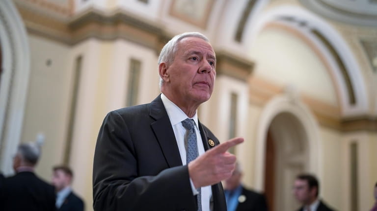 Rep. Ken Buck, R-Colo., walks out of the House chamber,...